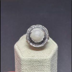 Sterling silver ring with white stone.